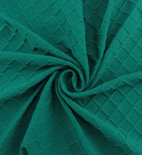 Photo of raw green spandex fabric in an attractive swirl to highlight the material's texture.