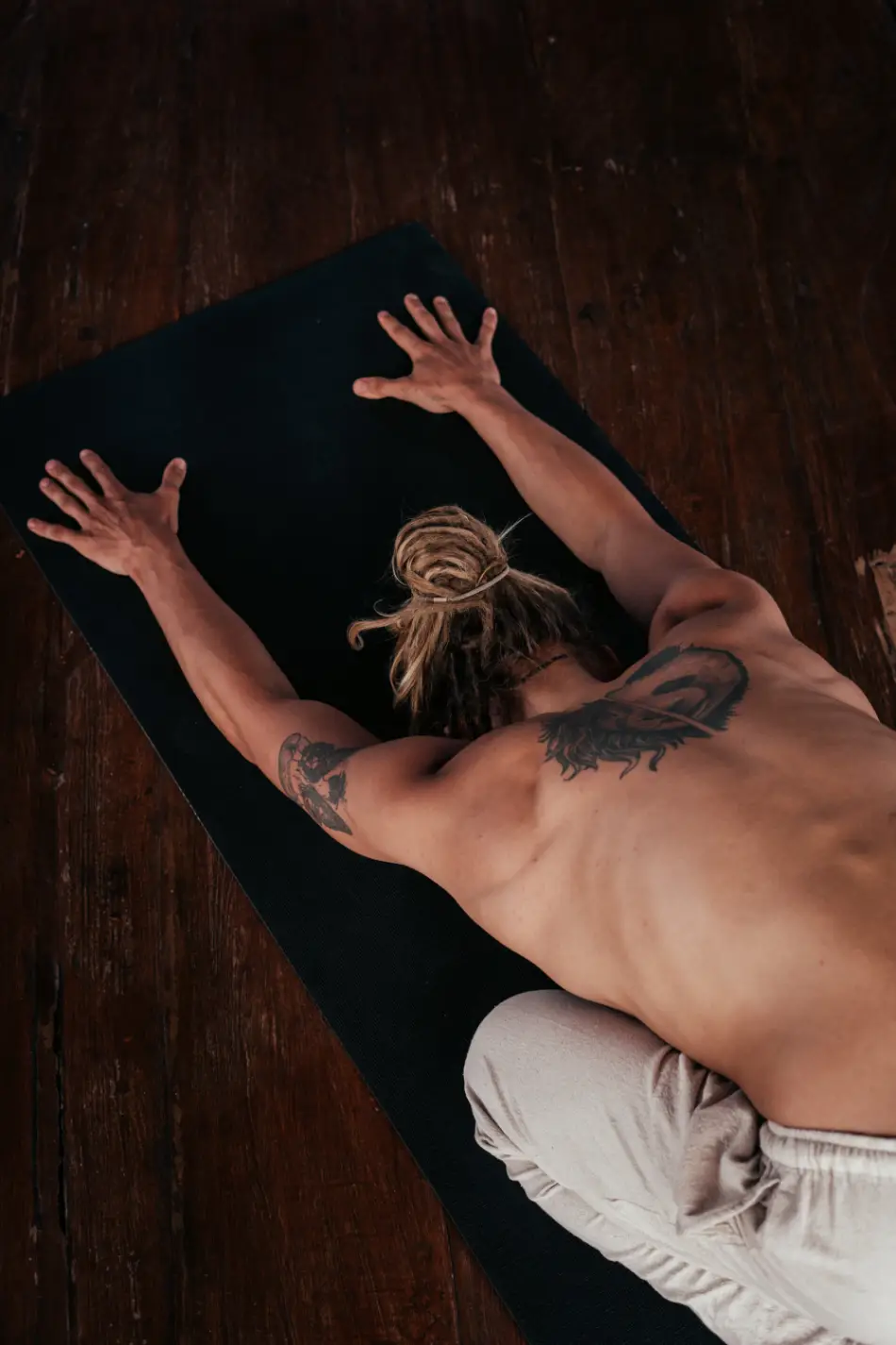 Man doing a yoga pose on a yoga mat.